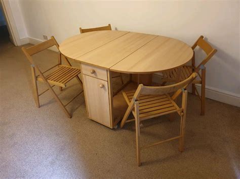 Fantastic space saving dining table with 4 folding chairs and storage ...