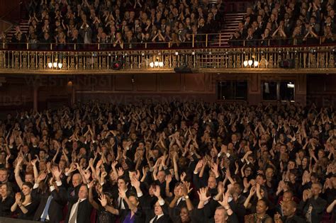 Audience cheering in theater stock photo