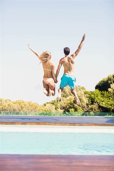 Happy Couple Jumping in the Pool Stock Image - Image of shorts, holiday ...