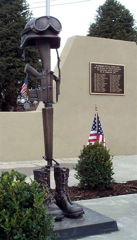 An actual-size bronze casting of the boots, M-16 rifle and helmet ...