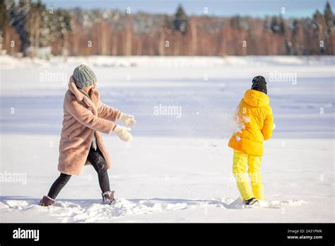 Happy family having fun outdoors in winter with snow Stock Photo - Alamy