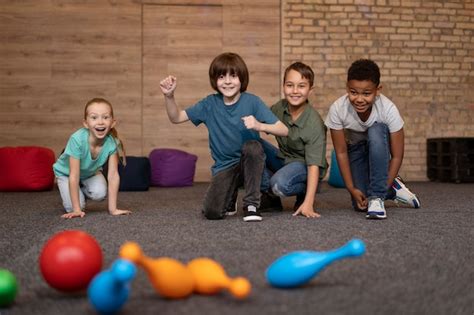 Premium Photo | Kids playing bowling full shot