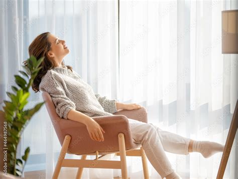 woman resting on armchair at home Stock Photo | Adobe Stock