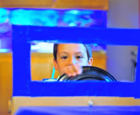 Premium Photo | Portrait of boy enjoying blue toy car ride
