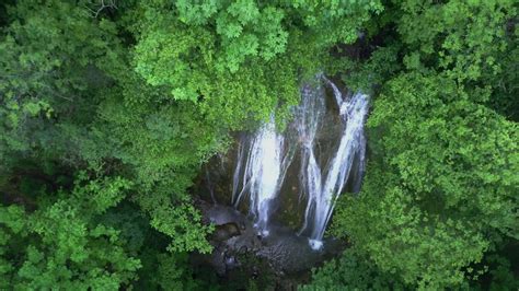 A waterfall in a mountain forest 24830922 Stock Video at Vecteezy