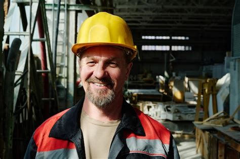 Premium Photo | Portrait of mature engineer in work helmet smiling at ...