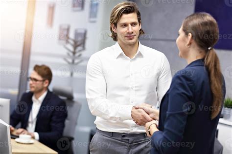 Business people shaking hands in the office 15764967 Stock Photo at Vecteezy