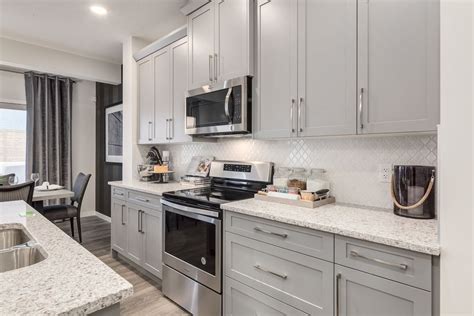 Look at that gorgeous white backsplash in this grey kitchen | All the stainless steel appliances ...