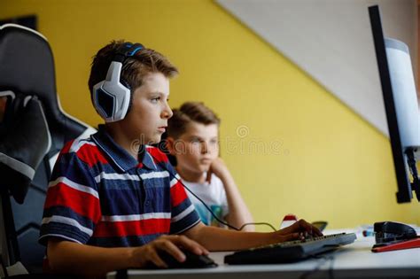 Two Kids Boys Playing Computer Games on Desktop Pc. Modern Addict ...