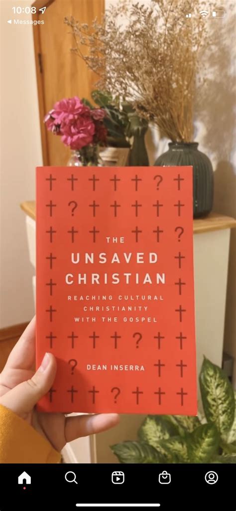 someone holding up a red book with the words unsaved christian on it