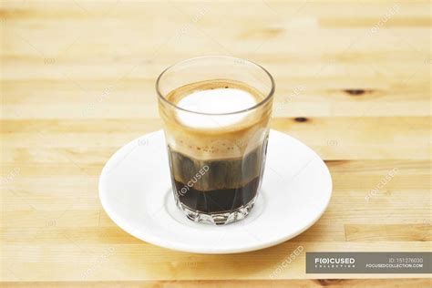 Espresso macchiato in glass cup — saucer, caffeine - Stock Photo | #151276030