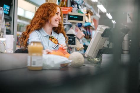 Woman working at grocery store checkout – Jacob Lund Photography Store- premium stock photo