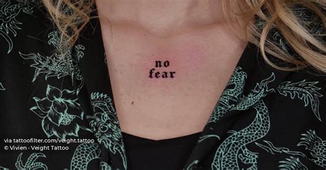 Lettering tattoo that says "no fear" located on the