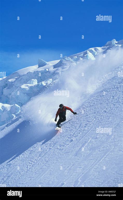 Snowboarder on mountain slope Stock Photo - Alamy