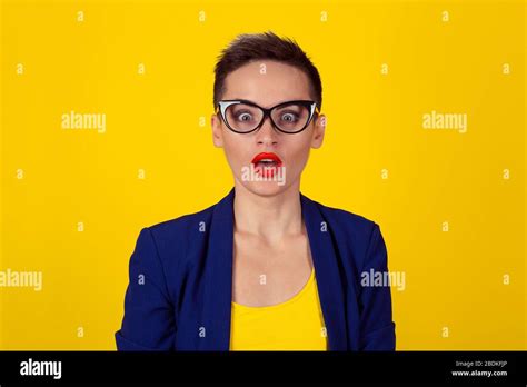 Amazed shocked business woman looking at camera open mouth isolated yellow background wall short ...