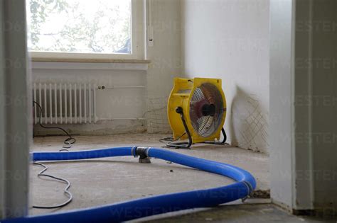 Dehumidifier at work in an apartment which is damaged by flooding stock ...