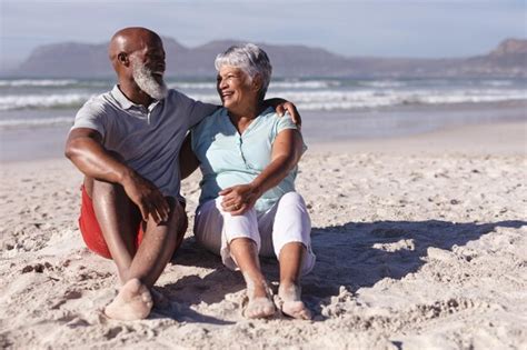 Premium Photo | Senior african american couple smiling while looking at ...