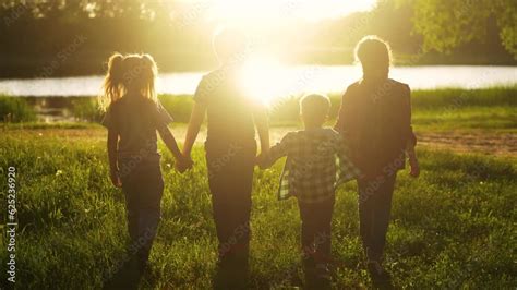 children in the park. happy family kid dream concept. a group of children walk in nature in the ...