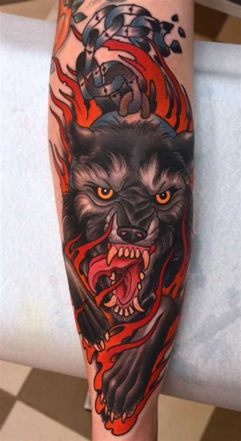 Amazing colored evil hell dog tattoo on forearm stylized with flames - Tattooimages.biz