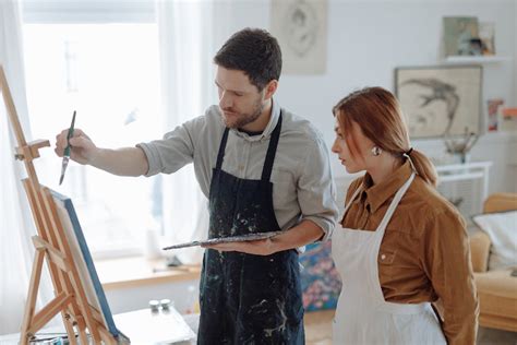 Woman Watching the Man Painting · Free Stock Photo