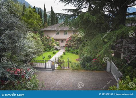 Luxury Blue House with Beautiful Landscaping on a Sunny Day Stock Photo ...