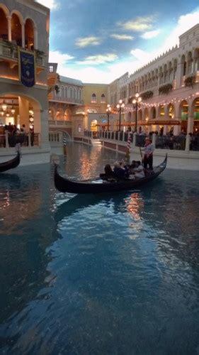 The Venetian in Las Vegas with gondola on an interior canal surrounded ...