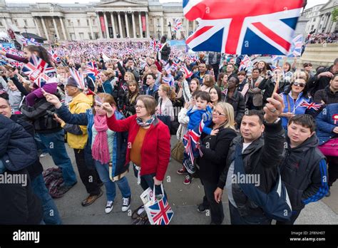 A large crowd of people gathered in Trafalgar Square to watch a giant ...