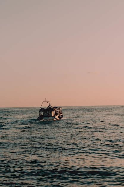 Premium Photo | Fishing boat at sunset