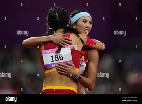 Gold medalist China's Lin Yuwei, right, is hugged by compatriot China's Wu Yanni after the women ...