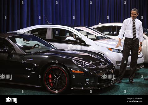 U.S. President Barack Obama looks at cars during a visit to the DC Auto ...