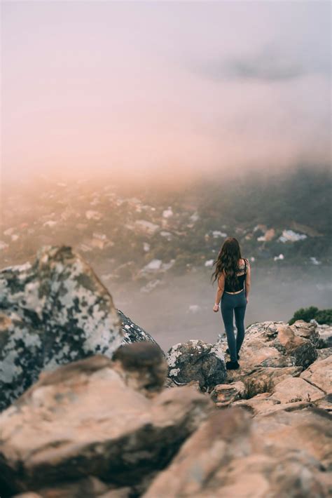 Woman Standing On The Edge Of A Cliff · Free Stock Photo