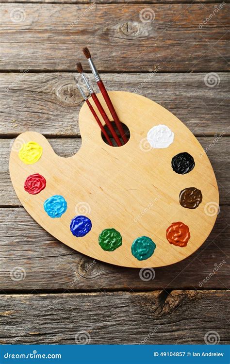 Wooden Art Palette With Paints On A Grey Wooden Background Stock Image ...