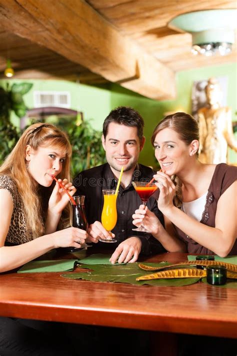 Young People Drinking Cocktails In Bar Stock Photos - Image: 27039413