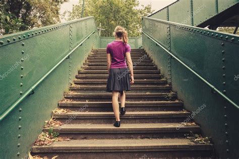 Young woman walking up stairs Stock Photo by ©lofilolo 55138423