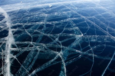 Bottomless ice of Lake Baikal in cracks. Stock Photo | Adobe Stock