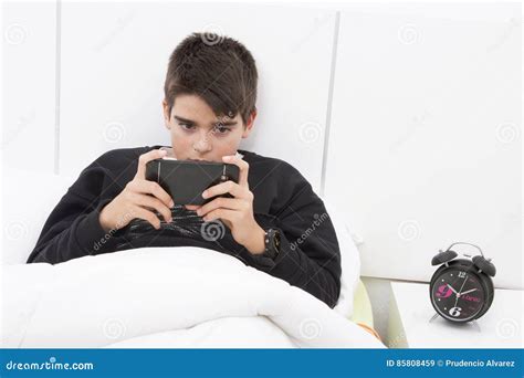 Child mobile phone on bed stock image. Image of child - 85808459