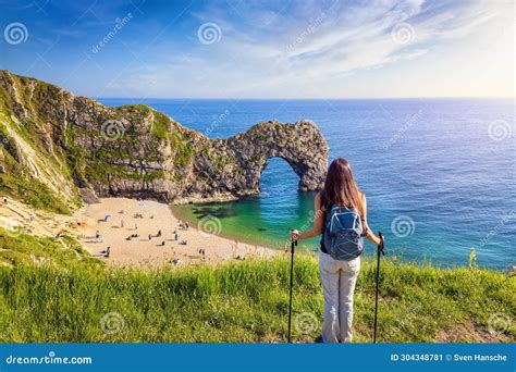 A Hiking Woman Stands in Front of the Famous Durdle Door Beach Stock Image - Image of english ...