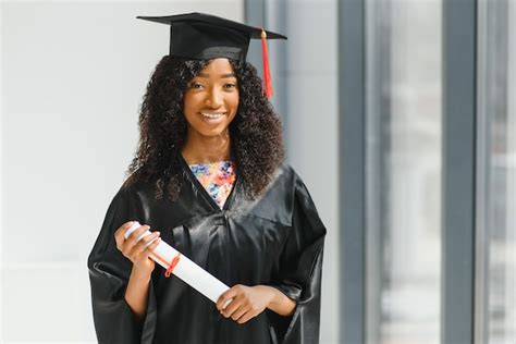 Premium Photo | Cheerful african-american female graduate standing in front of university building