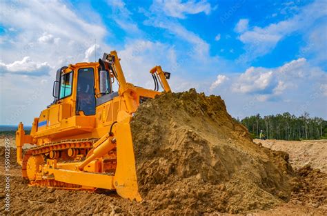 Crawler bulldozer working on construction site or quarry. Mining ...