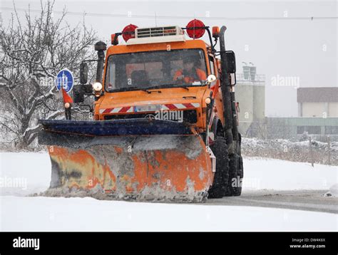 Mercedes Unimog snow plow in action, Winnenden, Germany, Febr. 12, 2010 ...