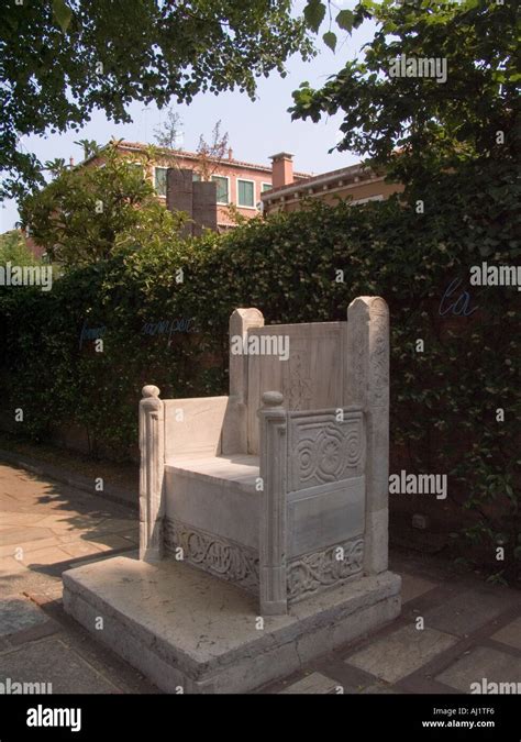 Carved stone chair in the outside garden of the Peggy Guggenheim ...