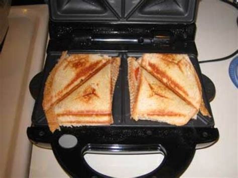 two grilled sandwiches sitting on top of a toaster