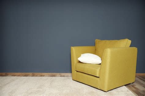 Premium Photo | Green armchair on dark grey wall background