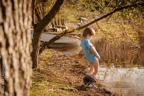 blond child pee in the lake Stock-Foto | Adobe Stock