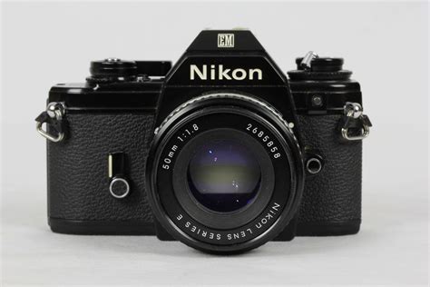 Nikon EM - A smaller and lighter all metal 35mm SLR. Automatic aperture priority with manual ...