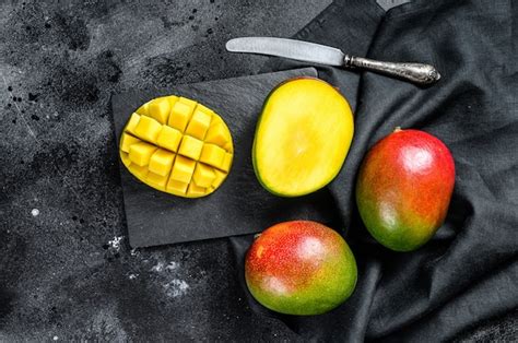 Premium Photo | Ripe mango fruit, cut into cubes. black background.