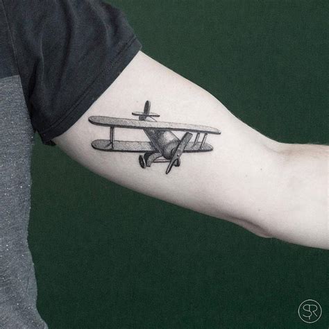 Airplane tattoos on the left inner arm.