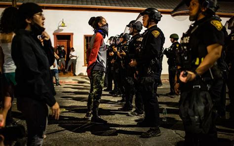 Tucson police confront protesters after windows smashed downtown