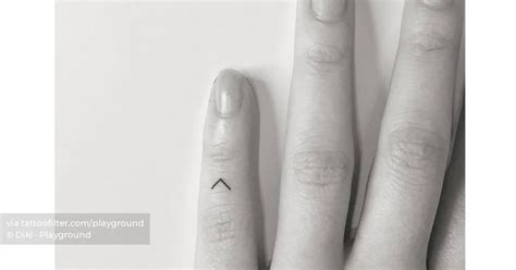 Kenaz rune tattooed on the finger, minimalistic style.