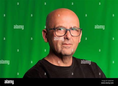 portrait bald man with glasses and green background Stock Photo - Alamy